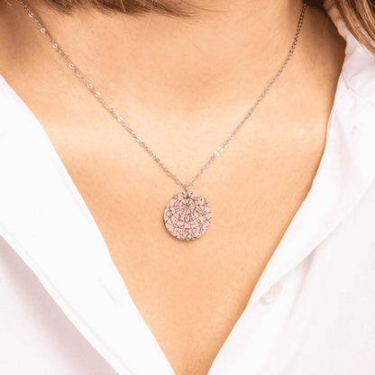 Woman with a white elegant shirt wearing a rose gold custom star map necklace.