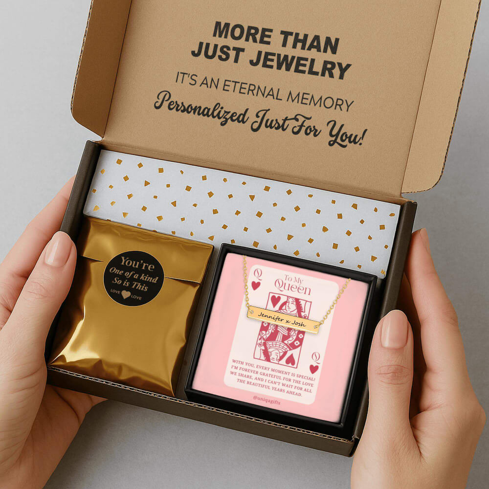 Personalized gold bar necklace packaging in a gift box with a greeting card and gold confetti paper, held by hands against a neutral background.